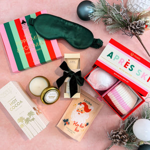Making Spirits Bright Luxury Christmas Gift Box For Women with 100% silk sleep mask, Musee Peppermint & Rosemary shower steamers and Aprés Ski Bath Bomb & Sock Set, Farmhouse Fresh Honey-Chai Steeped Milk Lotion, Compartés Hot Cocoa, Latika Santa Bath Fizzer, and Capri Blue Pumpkin Dulce Candle