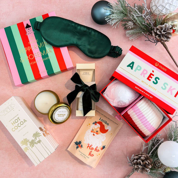 Making Spirits Bright Luxury Christmas Gift Box For Women with 100% silk sleep mask, Musee Peppermint & Rosemary shower steamers and Aprés Ski Bath Bomb & Sock Set, Farmhouse Fresh Honey-Chai Steeped Milk Lotion, Compartés Hot Cocoa, Latika Santa Bath Fizzer, and Capri Blue Pumpkin Dulce Candle