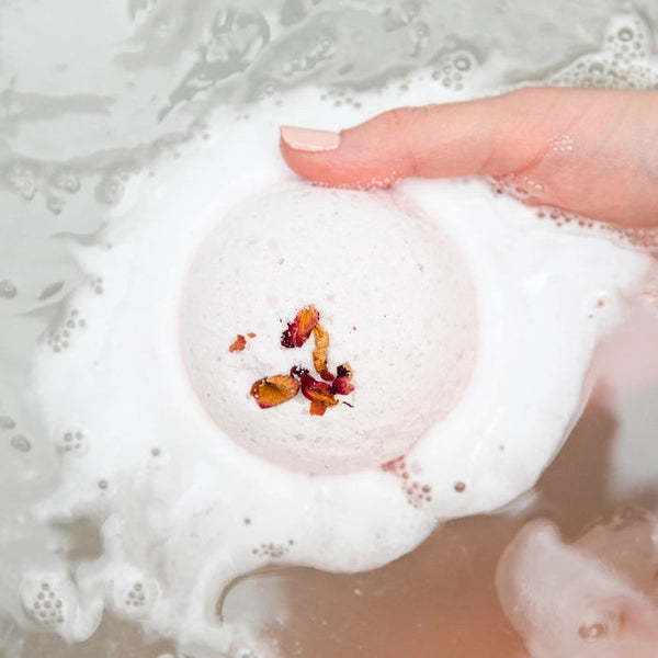 Bathorium Mama's Perch Bath bomb with dried flowers in a bubble bath
