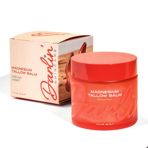 Red jar of Darlin Skincare Magnesium Tallow Balm with packaging on a white background