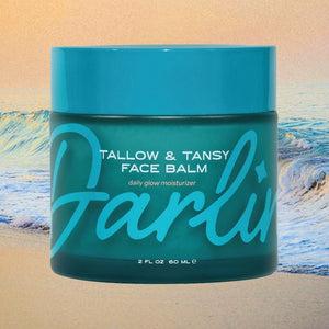 Blue jar of Darlin' Skincare Tallow & Tansy Face Balm with blue lid on a beach background | build a luxury custom gift box for women with Luxe & Bloom