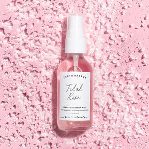 Bottle of Earth Harbor Tidal Rose Seaweed Hydration Mist on a pink textured background