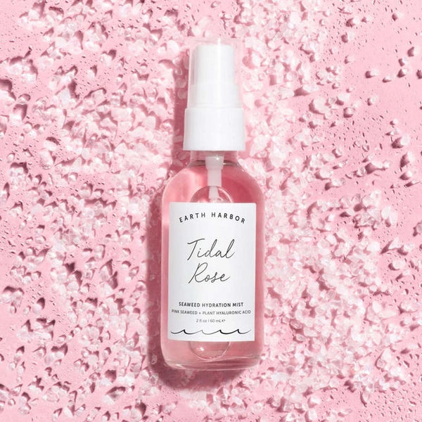 Bottle of Earth Harbor Tidal Rose Seaweed Hydration Mist on a pink textured background