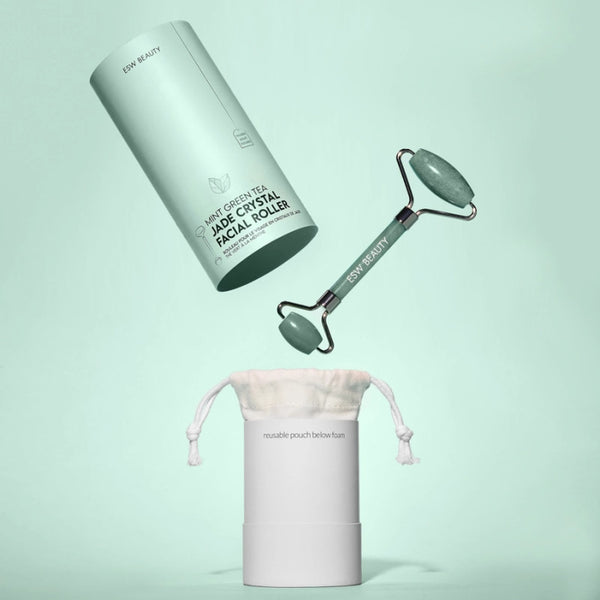 ESW Beauty Jade crystal facial roller with carrying pouch on a light green background | Build A Luxury Custom Gift Box with Luxe & Bloom