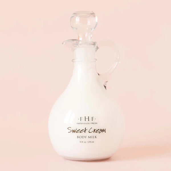 Glass bottle of F.H.F. Sweet Cream Body Milk on a pink background | Build A Luxury Custom Gift Box For Women with Luxe & Bloom