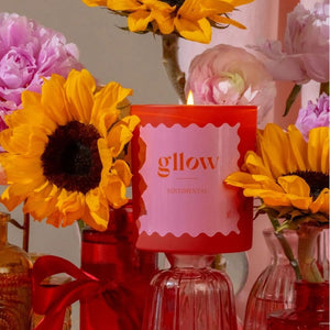 Gllow Sentimental Scented candle lwith sunflowers and pink flowers in the background | Build A Luxury Custom Gift Box for Women with Luxe & Bloom