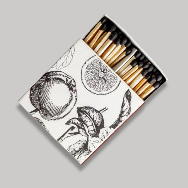 Matches in an open matchbox with black and white vintage fruit illustrations on a gray background |Build A Custom Gift Box for Women