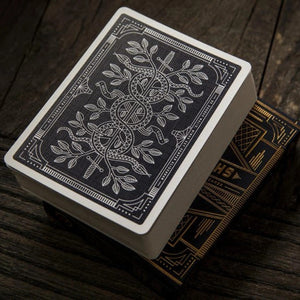 Theory 11 Monarch playing cards with intricate design on a wooden surface