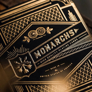 Close-up of Monarchs high-quality playing cards packaging with gold text and designs.