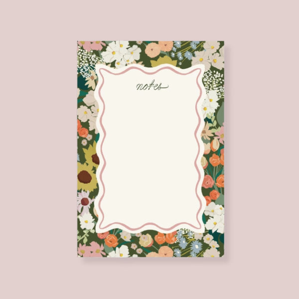 Amy Heitman Flower Market notepad with a cream center writing area framed by a multicolor floral border, shown on a solid pale lavender background | Build A Luxury Custom Gift Box for Women with Luxe & Bloom