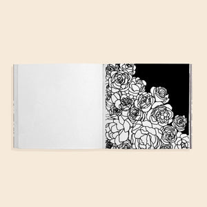 Coloring book open with floral design on a beige background