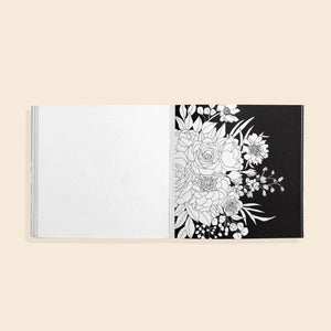 Coloring book open to a page with a floral design on a beige background