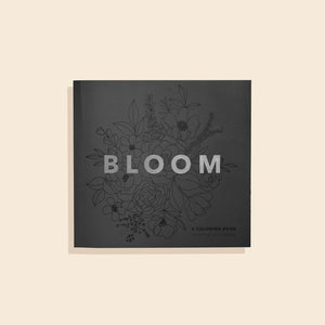 Coloring book titled 'Bloom' with floral illustrations on a beige background