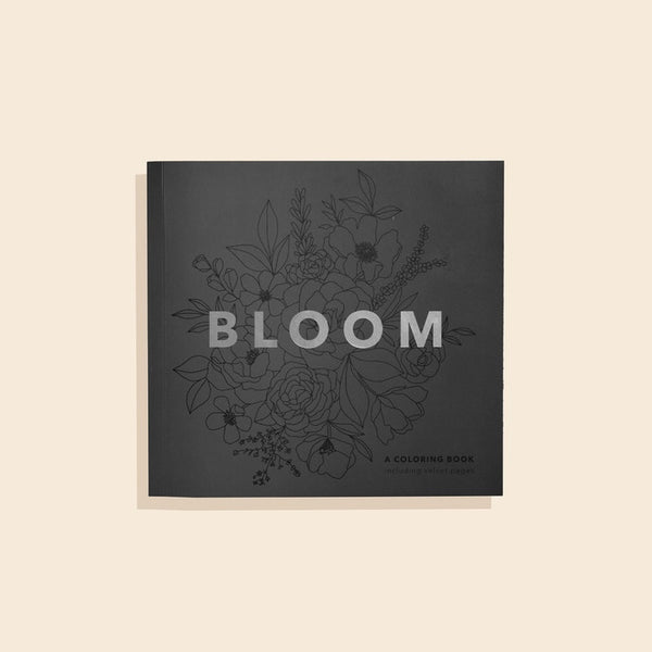 Coloring book titled 'Bloom' with floral illustrations on a beige background