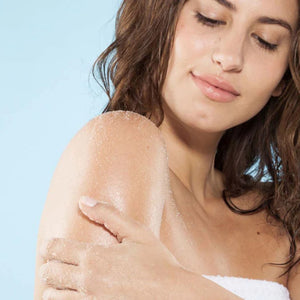 Woman applying Farmhouse Fresh Honey Lavender Fine Sea Salt Body Polish to her shoulder | Build A Luxury Custom Gift Box for Women with Luxe & Bloom