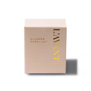 L'AVANT Collective Blushed Bergamot candle box in a pale blush pink color with gold foil lettering, set against a plain white background with a soft shadow.