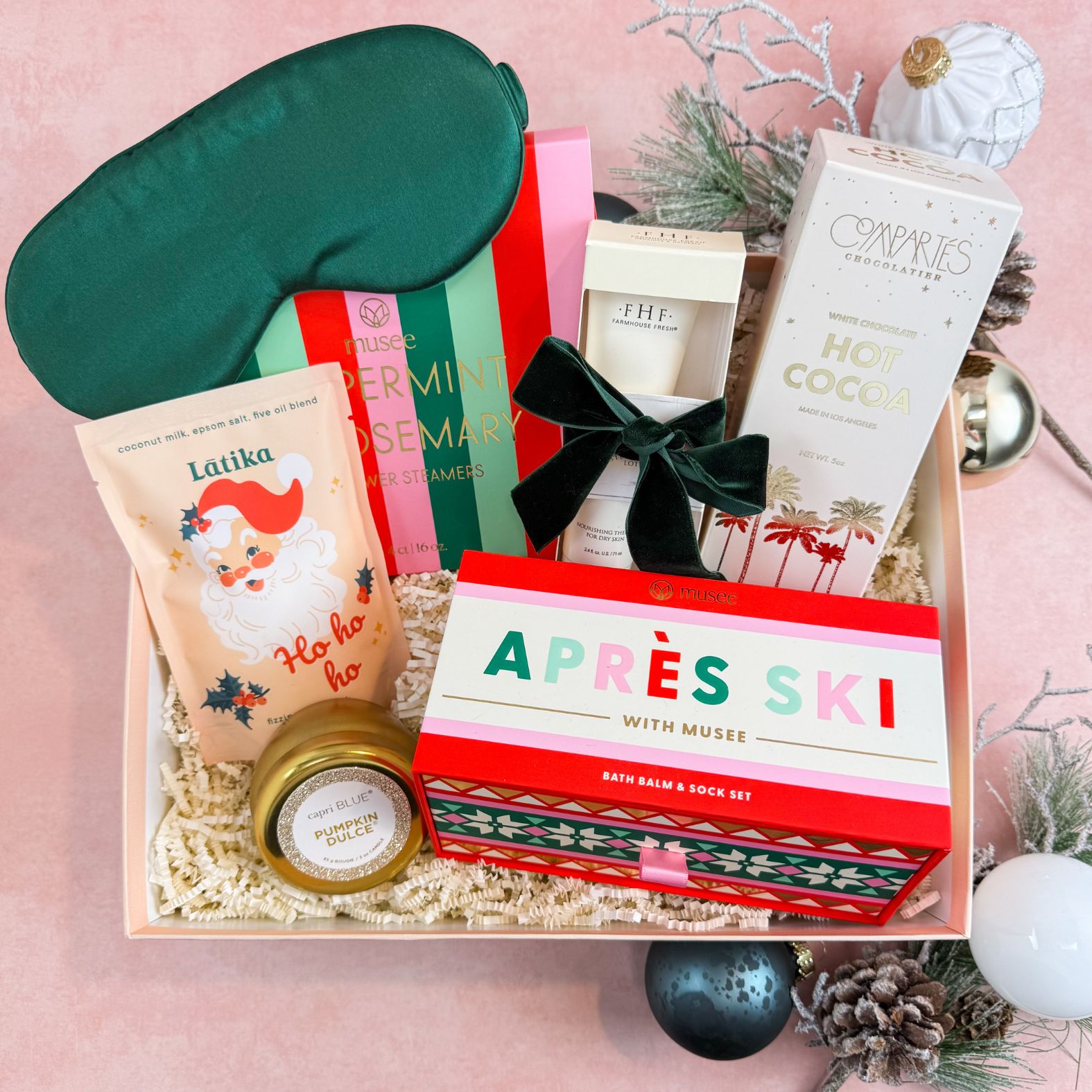Making Spirits Bright Luxury Christmas Gift Box For Women with 100% silk sleep mask, Musee Peppermint & Rosemary shower steamers and Aprés Ski Bath Bomb & Sock Set, Farmhouse Fresh Honey-Chai Steeped Milk Lotion, Compartés Hot Cocoa, Latika Santa Bath Fizzer, and Capri Blue Pumpkin Dulce Candle