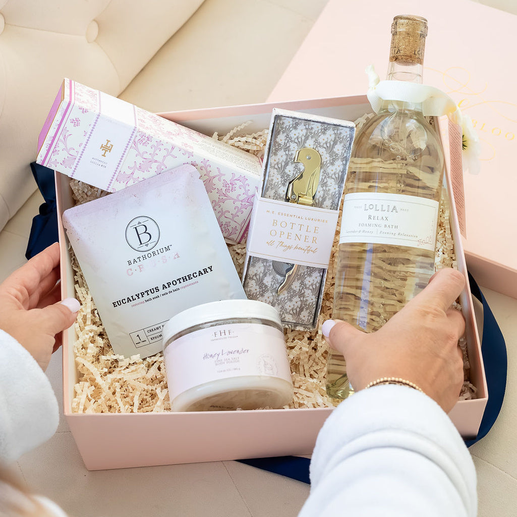 Spa Day Luxury Curated Gift Box for Women from Luxe & Bloom. Includes Lollia Relax Bubble Bath, Lollia Relax Shea Butter Handcreme, Gold Bottle Opener, Bathorium Eucalyptus Apothecary Bath Soak, and Farmhouse Fresh Honey Lavender Body Polish