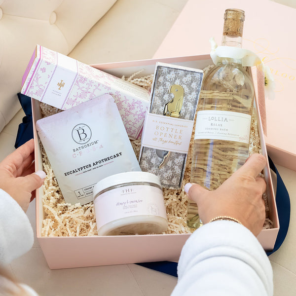 Spa Day Luxury Curated Gift Box for Women from Luxe & Bloom. Includes Lollia Relax Bubble Bath, Lollia Relax Shea Butter Handcreme, Gold Bottle Opener, Bathorium Eucalyptus Apothecary Bath Soak, and Farmhouse Fresh Honey Lavender Body Polish