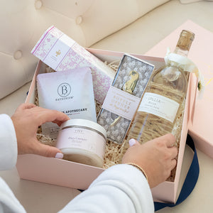 Spa Day Luxury Curated Gift Box for Women from Luxe & Bloom. Includes Lollia Relax Bubble Bath, Lollia Relax Shea Butter Handcreme, Gold Bottle Opener, Bathorium Eucalyptus Apothecary Bath Soak, and Farmhouse Fresh Honey Lavender Body Polish
