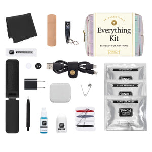 Pinch Provisions Puffer Everything Kit contents including a bandage, nail clipper, USB cable, and various personal care products on a white background.