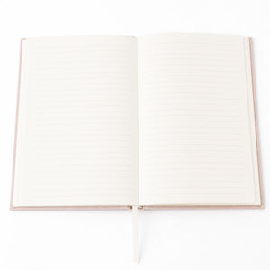 An open Selah Publications Lainey notebook with cream-colored pages and a linen colored cover, shown on a clean white background.