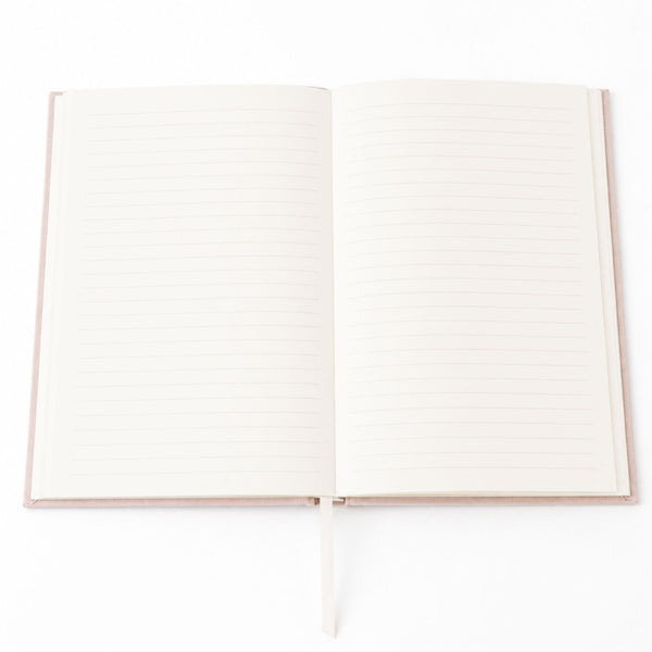 An open Selah Publications Lainey notebook with cream-colored pages and a linen colored cover, shown on a clean white background.