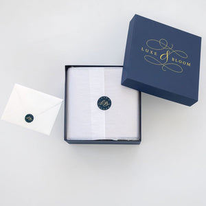 Open small luxury navy gift box with interior wrapping and card from Luxe & Bloom