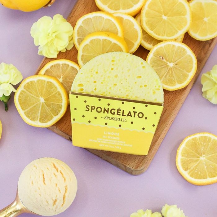 Spongelle Limone Spongelato Body Buffer with lemon slices on a wooden board and purple background | Build A Luxury Custom Gift Box for Women with Luxe & Bloom