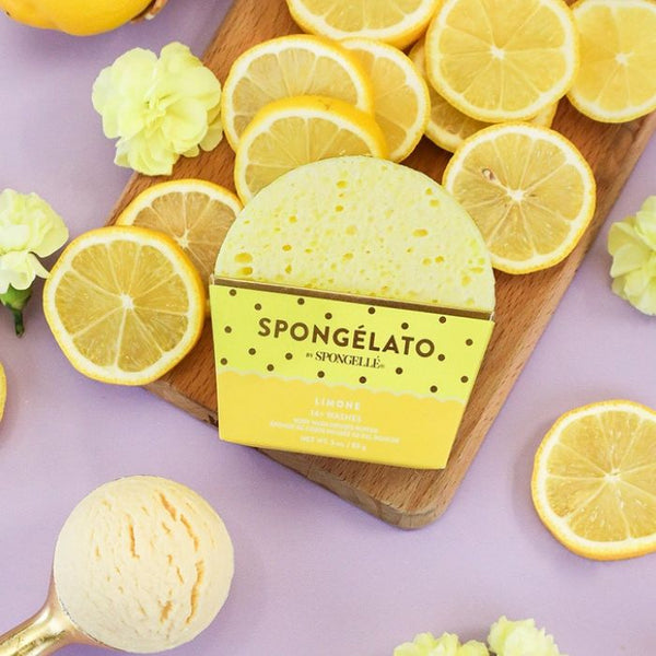 Spongelle Limone Spongelato Body Buffer with lemon slices on a wooden board and purple background | Build A Luxury Custom Gift Box for Women with Luxe & Bloom