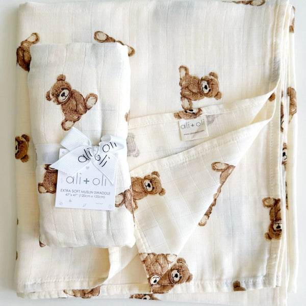 Ali + Oli Baby swaddle blanket with teddy bear pattern on a white background
