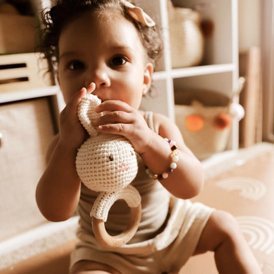 Ali + Oli Crocheted bunny rattle with wooden ring on a white background | build a custom baby gift box with Luxe & Bloom