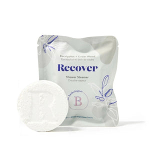 The Bathologist Recover Shower Steamer with green packaging on a white background | Build A Luxury Custom Gift Box for Women with Luxe & Bloom
