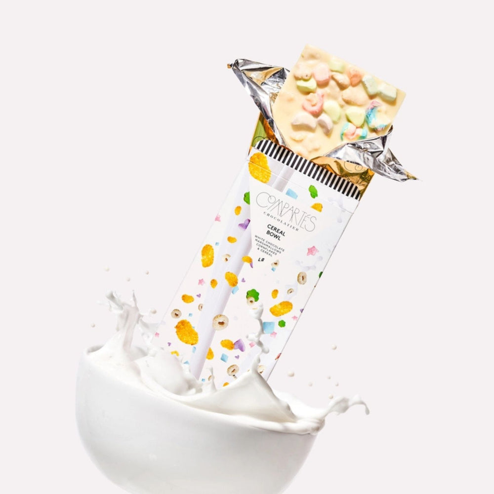 Compartes Cereal Bowl Chocolate Bar coming out of a white bowl of milk on a white background | Build A Custom Gift Box with Luxe & Bloom