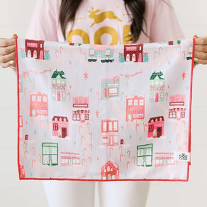 Woman holding Doe A Deer Christmas in the Village Waffle Kitchen Towel | Build A Luxury Custom Christmas Gift Box for Women with Luxe & Bloom