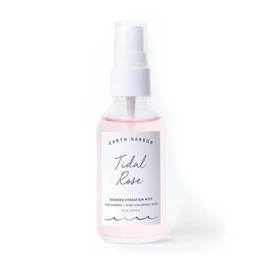 Bottle of Earth Harbor Tidal Rose Seaweed Hydration Mist on a pink textured background