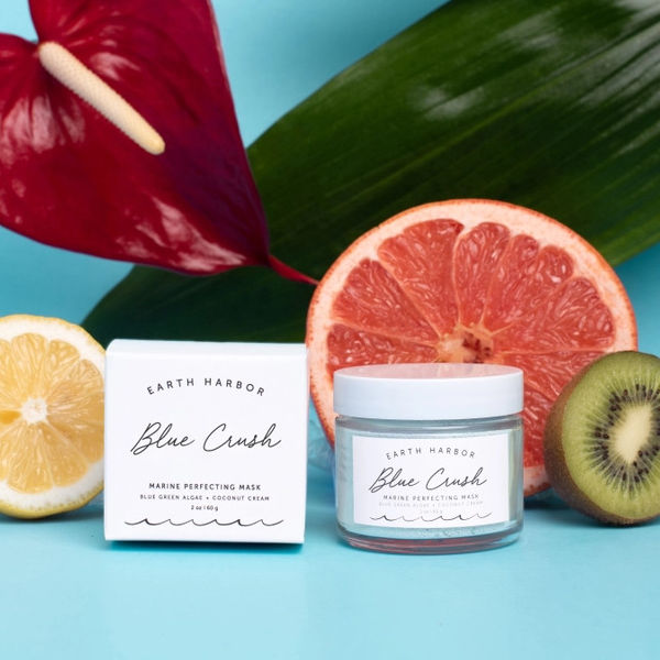 Earth Harbor Blue Crush marine perfecting mask with lemons, grapefruit, and kiwi on a blue background