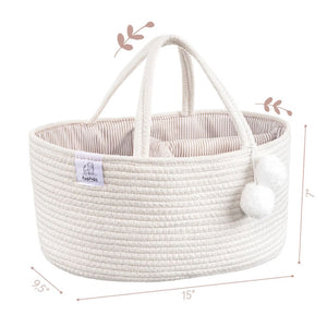 White woven diaper caddy with handles and pom-poms on a white background