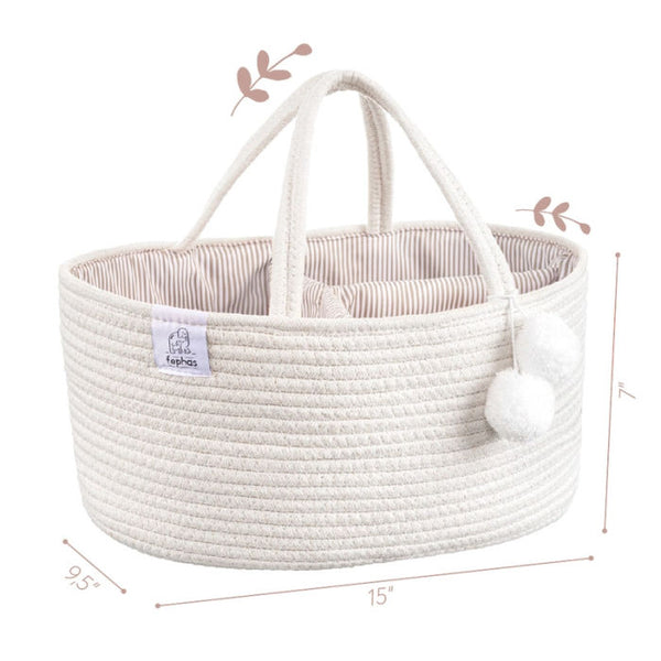 White woven diaper caddy with handles and pom-poms on a white background
