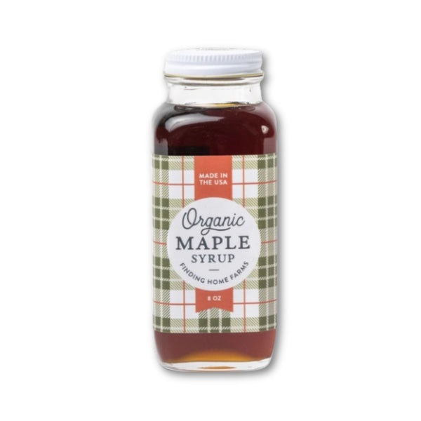 Bottle of Finding Home Farms organic maple syrup in limited edition Holiday bottle with a label on a white background