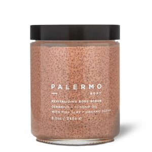 A jar of Palermo Body Revitalizing Body Scrub with pink clay and organic sugar, featuring a speckled pink scrub inside a clear glass jar with a black lid, on a white background | Build A Luxury Custom Gift Box for Women with Luxe & Bloom