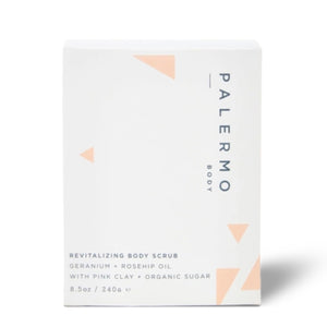 A white rectangular box of Palermo Body Revitalizing Body Scrub, featuring minimalist peach-colored geometric accents and black text on a clean white background.
