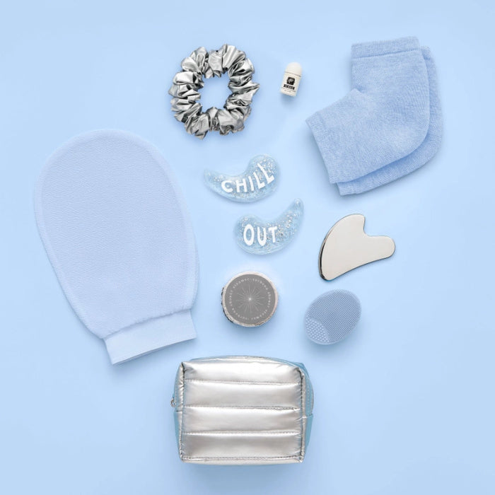 Pair of mittens holding a Pinch Provisions Winter Wellness Kit labeled 'Permission to Chill' on a light gray background.