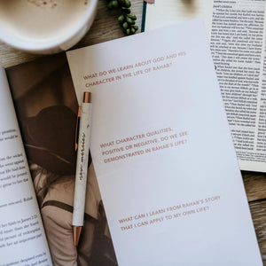 The Daily Grace Co. Daughters of Grace Bible Study open on a table with a pen | Build A Luxury Christian Custom Gift Box for Women with Luxe & Bloom